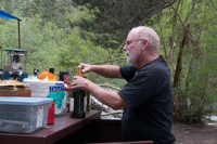 man opening wine bottle
